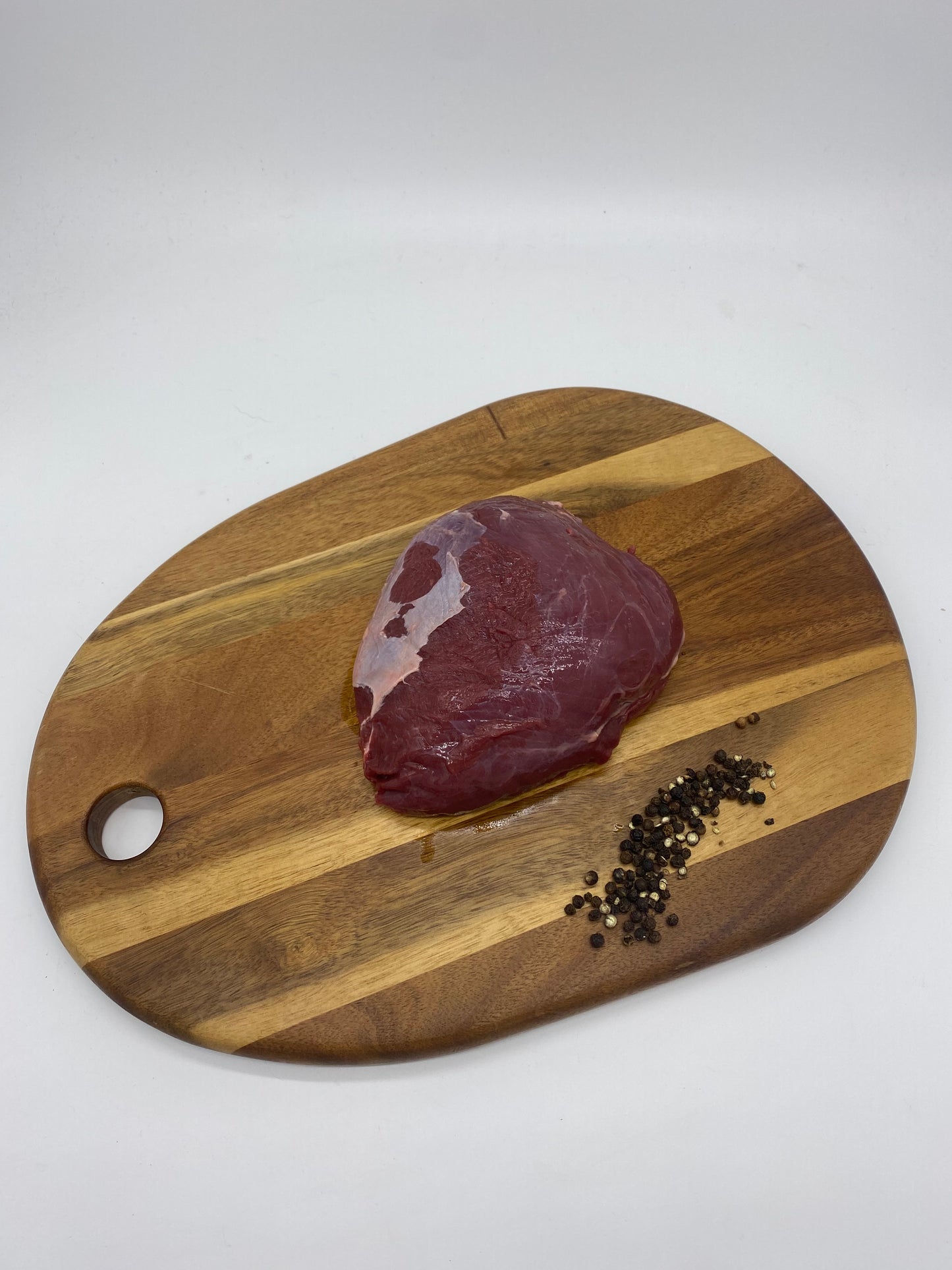 Kanagroo Rump Roast on a wooden board close view