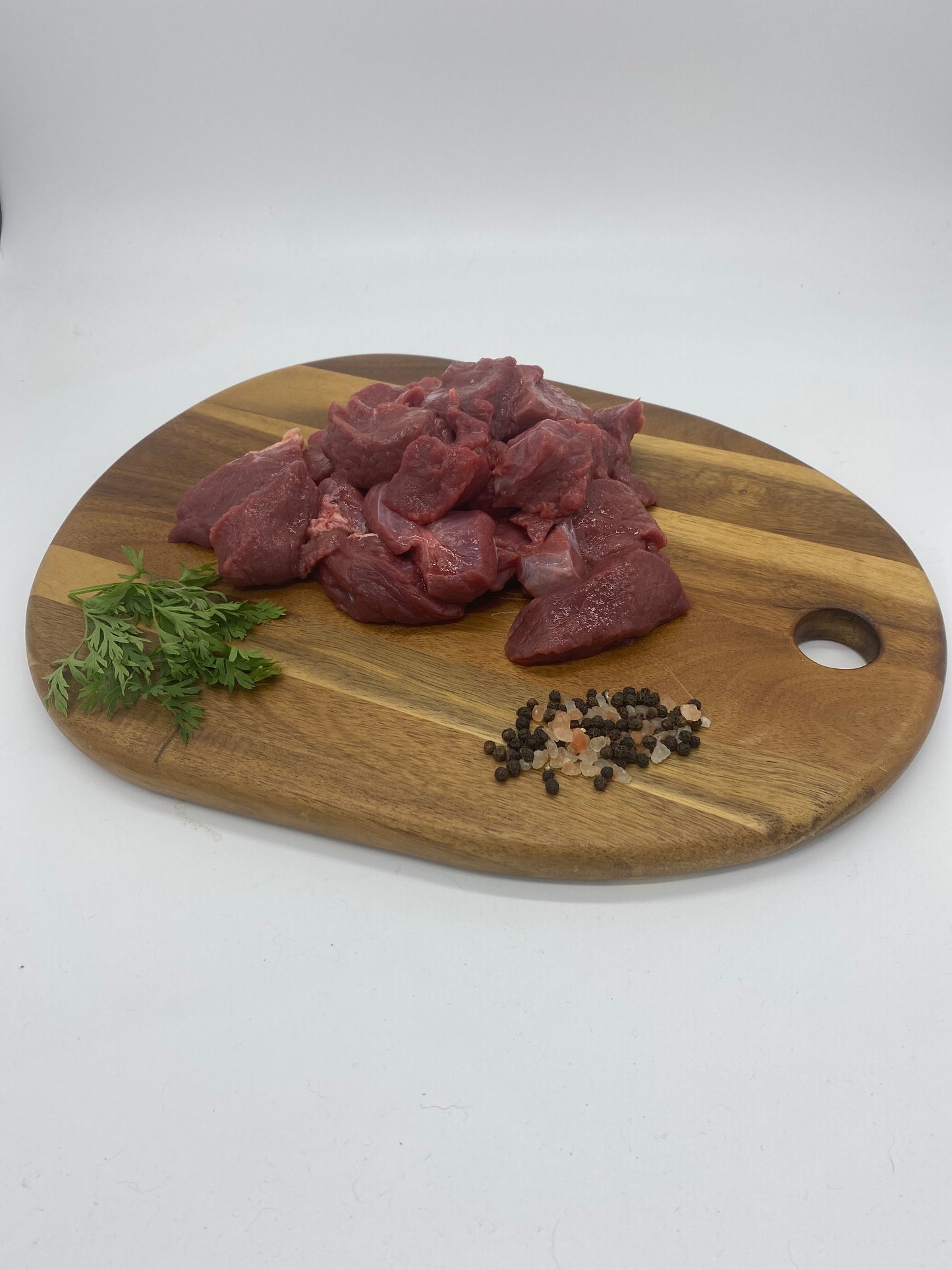 Photo - Diced venison on a wooden board