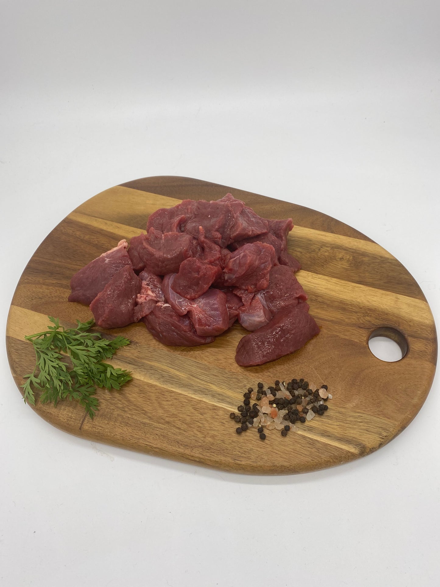 Photo - Diced venison on a wooden board
