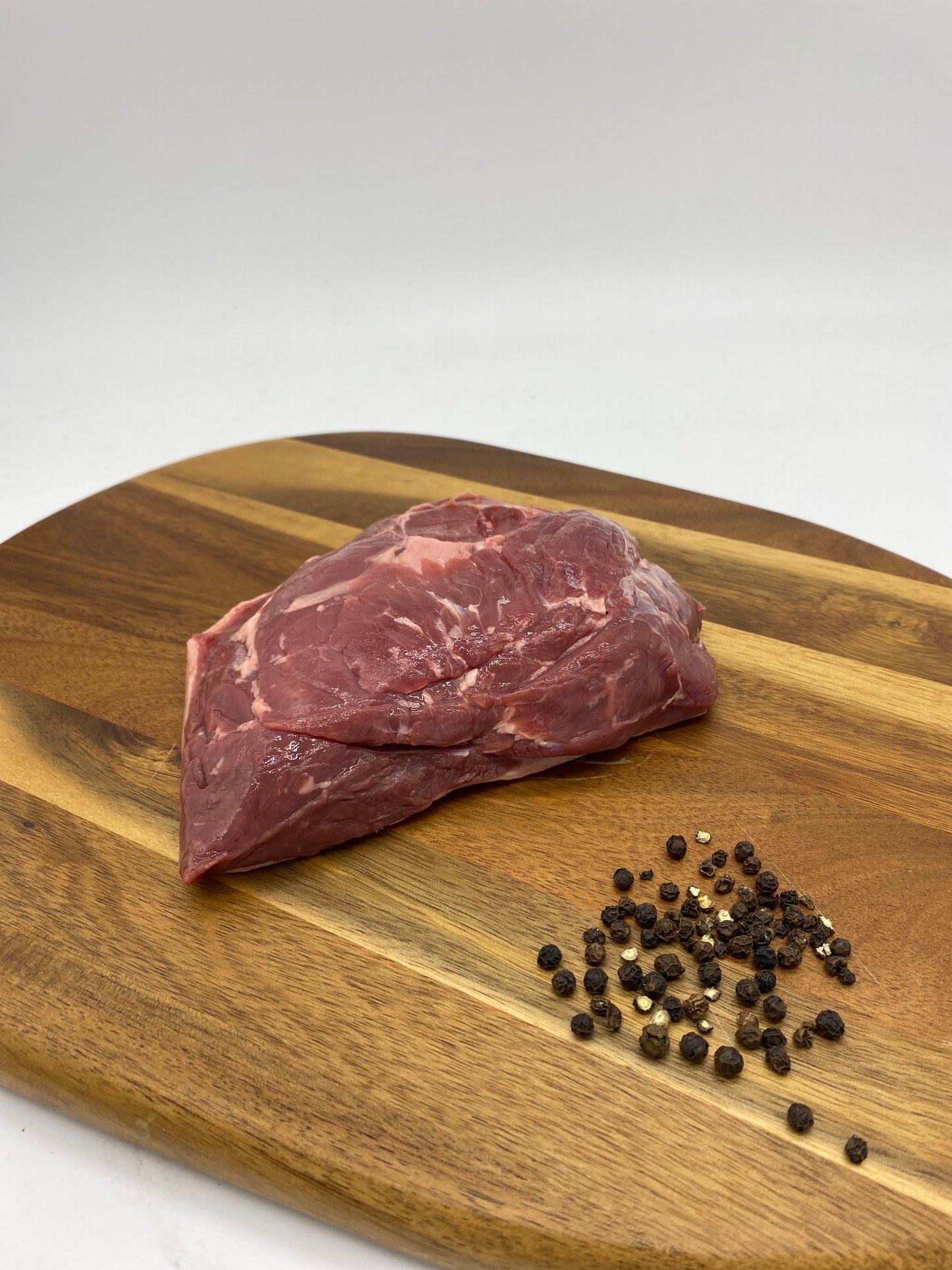 Photo close up of Venison Rump Roast on a wooden board