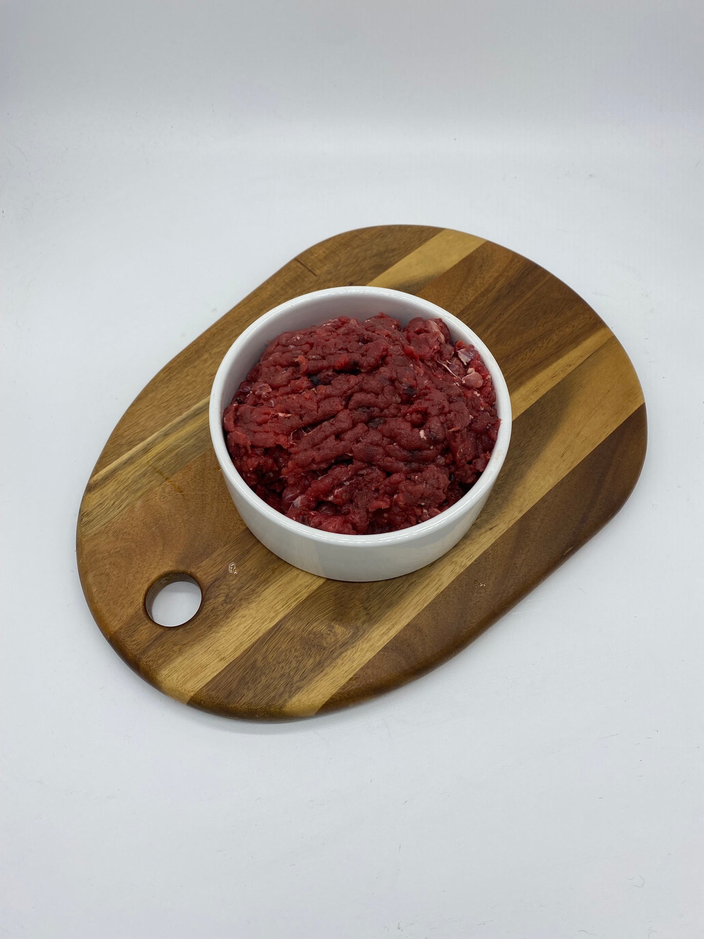 Overhead view of Minced kangaroo in a white dog bowl