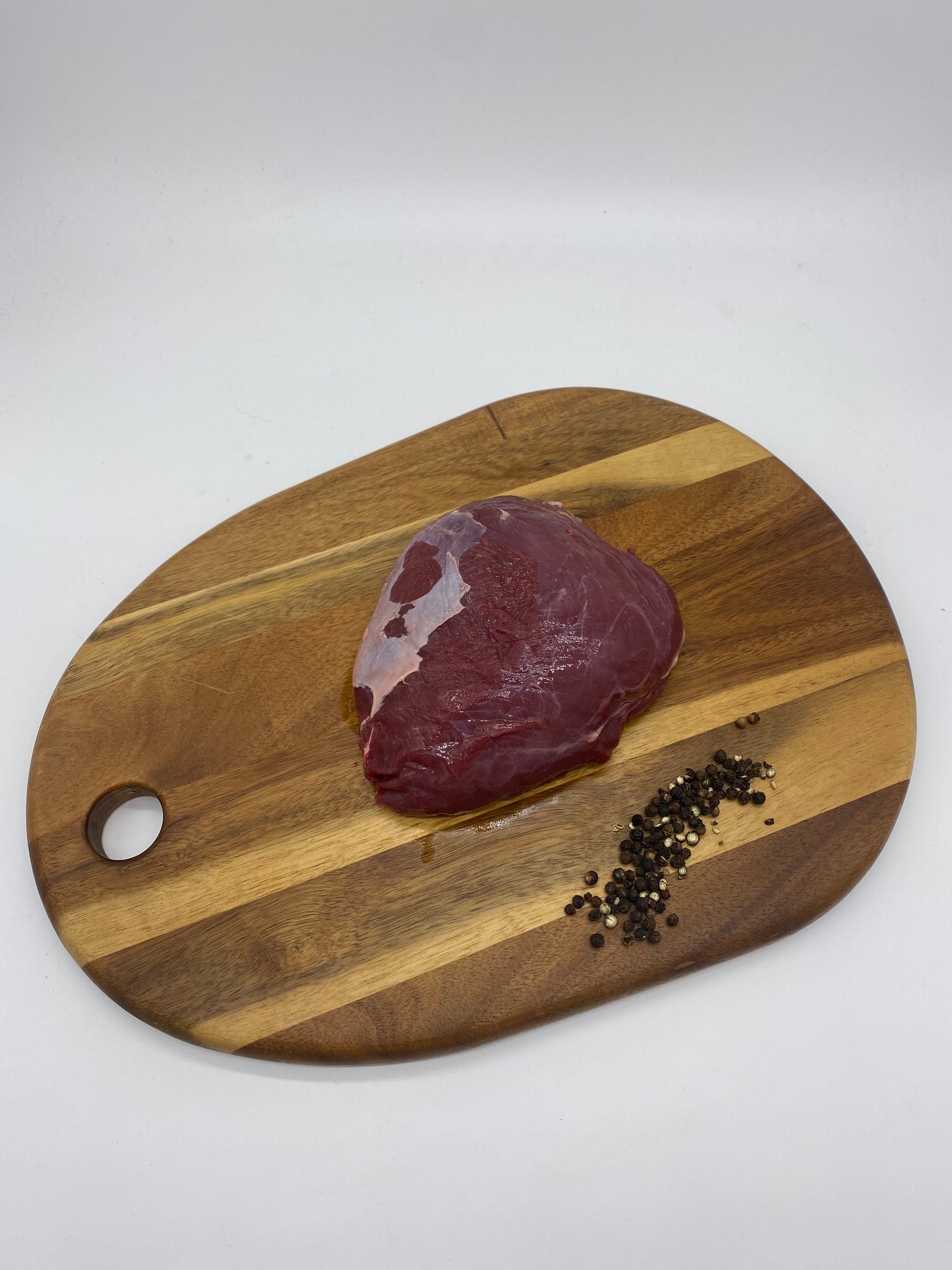 Kanagroo Rump Roast on a wooden board close view